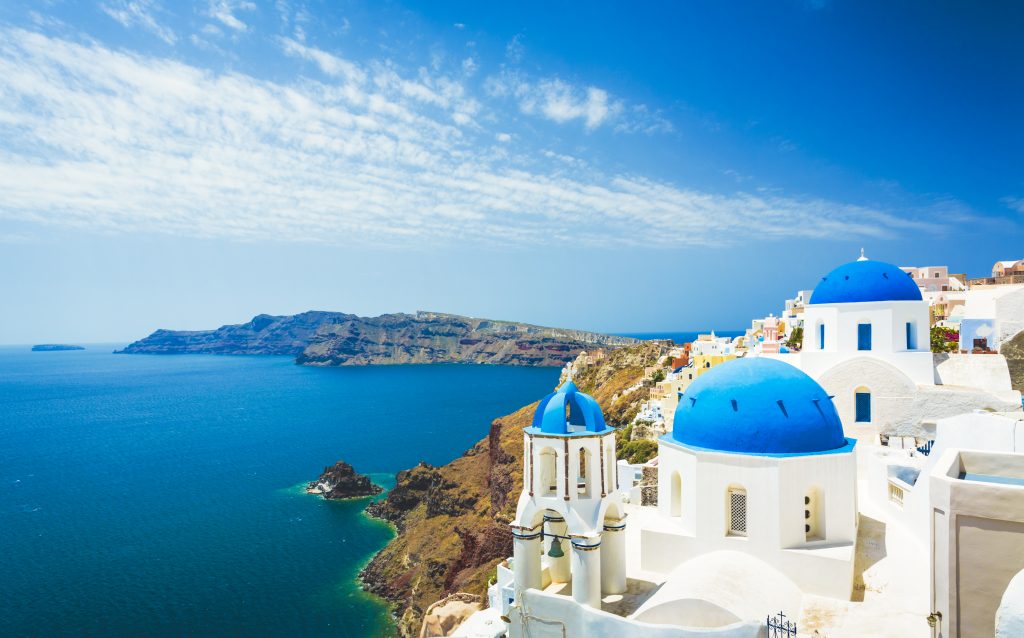 White and blue buildings in Santorini, Greece - Accent on Travel