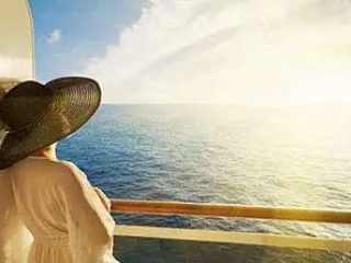 woman looking out at ocean from her balcony - Accent On Travel