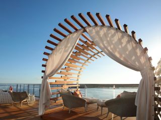 Balcony view of the ocean with chairs on a Celebrity cruise ship in Galapagos - Accent On Travel