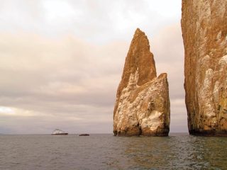 Celebrity cruise ship near rocks in Galapagos - Accent On Travel