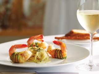 A plate of prawns & spaghetti. Fine dining on a Oceania cruise - Accent On Travel