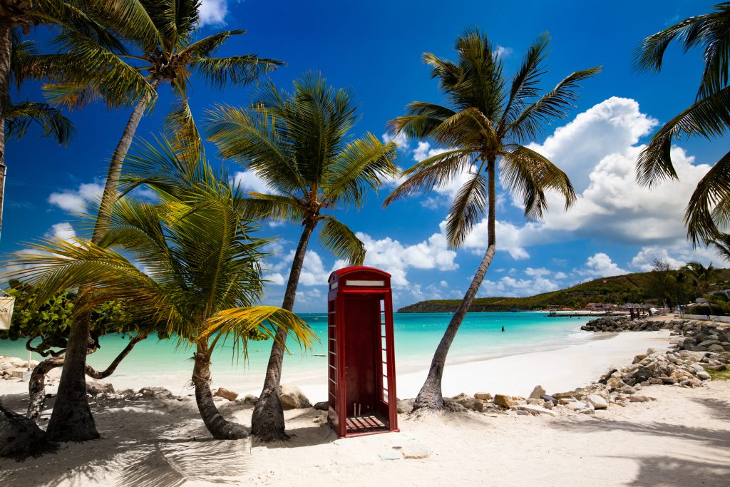 tropical palm trees and telephone booth, perfect beach, Dickenson Bay, Antigua - Accent on Travel