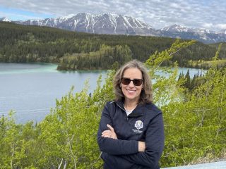Lisarose Rosenberger - with flowing river behind her - Accent on Travel