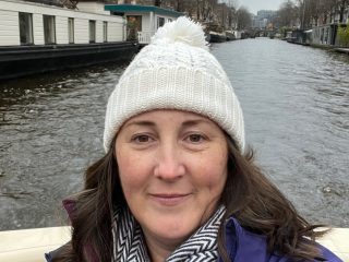 Heather McClatchey standing on bridge on vacation